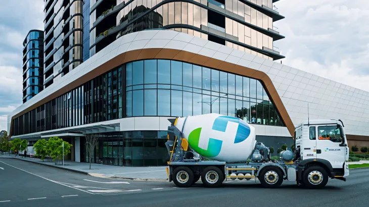 Holcim truck in front of building
